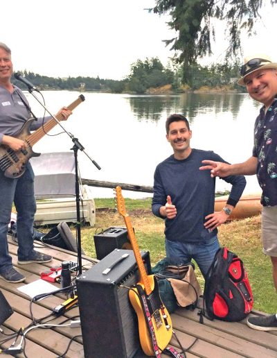 The band outside by a lake